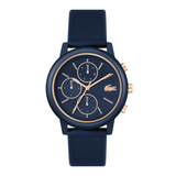 A Lacoste chronograph watch with a dark navy blue textured strap, matching navy blue dial, and rose gold accents including the logo, hands, markers, and pushers, shown on a solid white background.