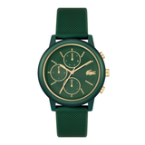 A green chronograph watch with a textured green strap, a matching green dial with gold-tone hands and markers, and a gold-tone Lacoste crocodile logo on the face, shown against a plain white background.