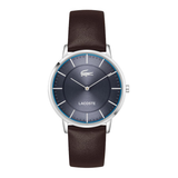 A Lacoste watch with a dark brown leather strap, a silver-toned case, and a dark blue dial with a blue inner ring.