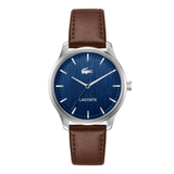 A Lacoste watch with a silver-tone stainless steel case, a textured blue dial with silver-tone indices, and a brown leather strap, shown against a plain white background.