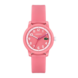 A pink Lacoste analog watch with a textured silicone strap, a pink dial with white Arabic numerals, and a small green crocodile logo at the 3 o'clock position.
