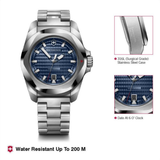 Silver watch with blue face on a white background, featuring Victorinox branding.