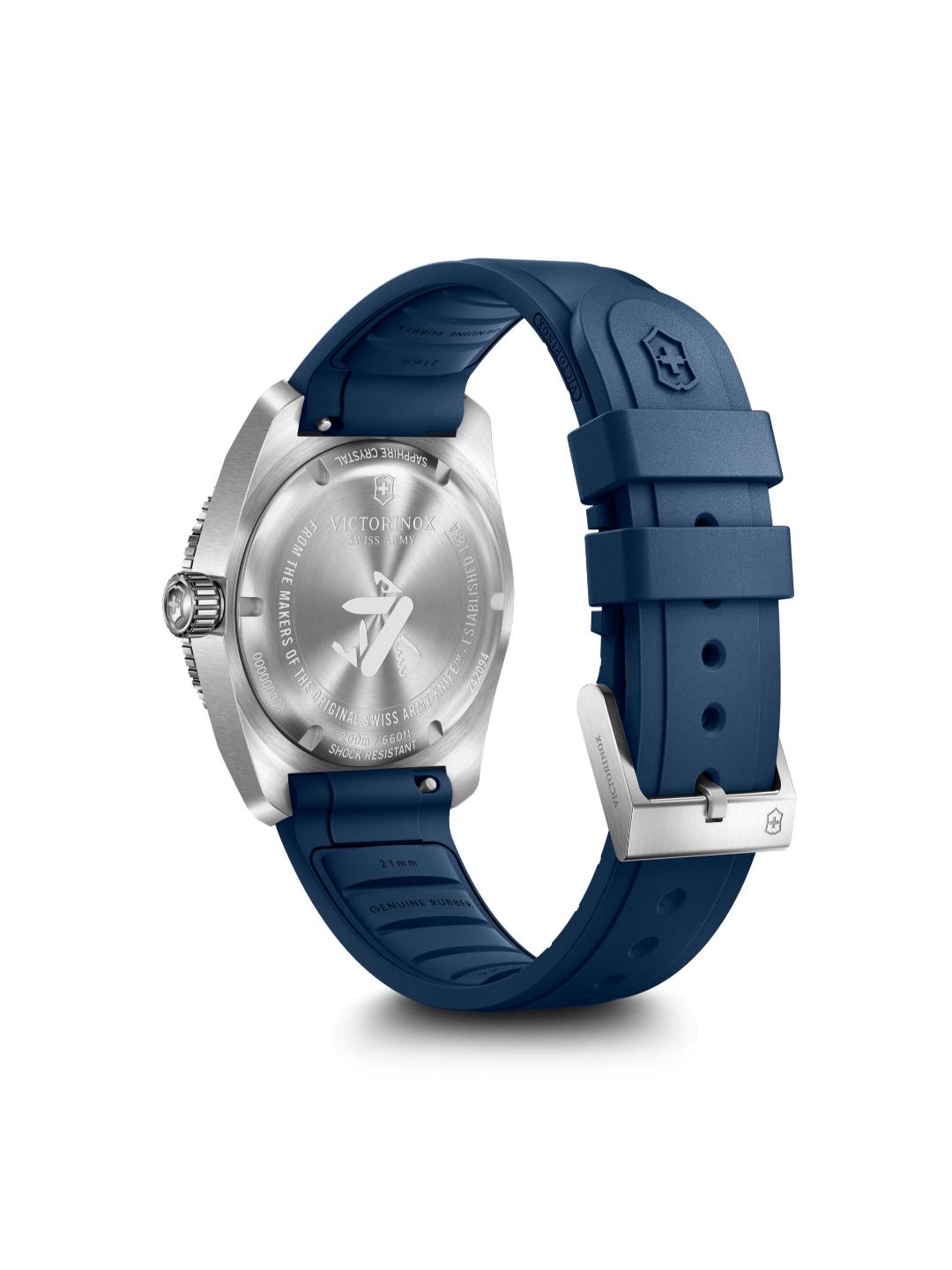 Swiss Pilot wristwatch shown from the back, featuring a silver stainless steel case and a dark blue silicone strap with a silver buckle.