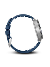 A close-up side view of a smartwatch with a dark blue silicone strap and a silver stainless steel case, shown against a plain white background.