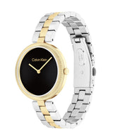 Calvin Klein watch with two-tone silver and gold bracelet on a white background
