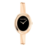 Calvin Klein women's watch featuring a slim oval black dial, rose gold case, and matching rose gold silicone strap, shown against a plain white background.