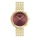 Calvin Klein women's watch featuring a gold-tone metal link bracelet, a bezel encrusted with small clear crystals, and a metallic rose gold dial with gold-tone hands.