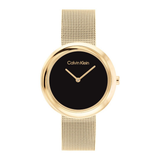 Calvin Klein women's watch featuring a round gold-tone case, a minimalist black dial with gold-tone hands, and a matching gold-tone mesh strap, shown against a plain white background.