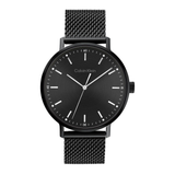 Calvin Klein analog watch with a black round case, black textured dial, and a black mesh metal strap, shown against a plain white background.