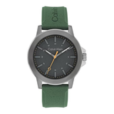 Calvin Klein analog watch with a dark gray dial, silver-tone case, and green textured strap, shown on a plain white background.