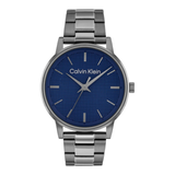 Calvin Klein men's analog watch with a textured blue dial and a silver stainless steel link bracelet, shown against a plain white background.