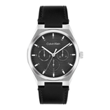 Calvin Klein men's watch featuring a silver stainless steel case, a textured black dial with three sub-dials, and a black leather strap, shown against a plain white background.