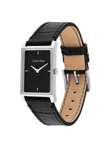 Calvin Klein watch with a rectangular black dial, silver-tone case, and black leather strap with tan interior, shown on a white background.