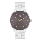 A Calvin Klein watch with a silver stainless steel link bracelet, a silver case, and a dark gray dial with a yellow second hand.