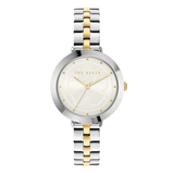 Two-tone silver and gold watch with a white face on a white background, brand 'Ted Baker' visible.