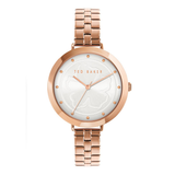 Rose gold watch with white face on a white background, Ted Baker brand visible