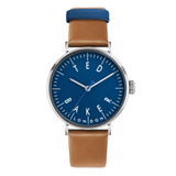 Watch with blue dial and brown leather strap on a white background