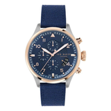 Ted Baker men’s chronograph wrist watch featuring a 44 mm round blue dial with rose gold-tone bezel accents, three subdials, date window, silver case, and blue fabric strap on white background.