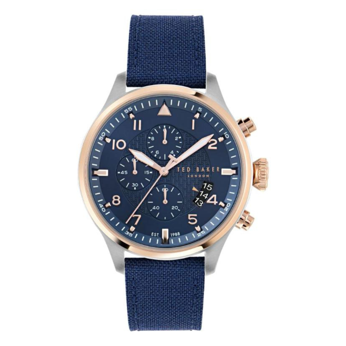 Ted Baker men’s chronograph wrist watch featuring a 44 mm round blue dial with rose gold-tone bezel accents, three subdials, date window, silver case, and blue fabric strap on white background.