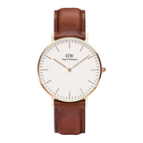 Watch with brown leather strap and gold case on white background