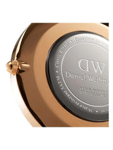 Close-up of a Daniel Wellington watch back with rose gold case and silver dial.