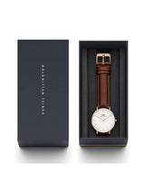 Daniel Wellington watch with brown leather strap in a black box on a white background