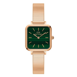 Gold watch with green face on a white background