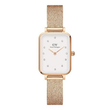 Rose gold watch with a white face on a white background