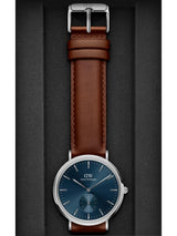 Watch with brown leather strap and blue dial on a gray background