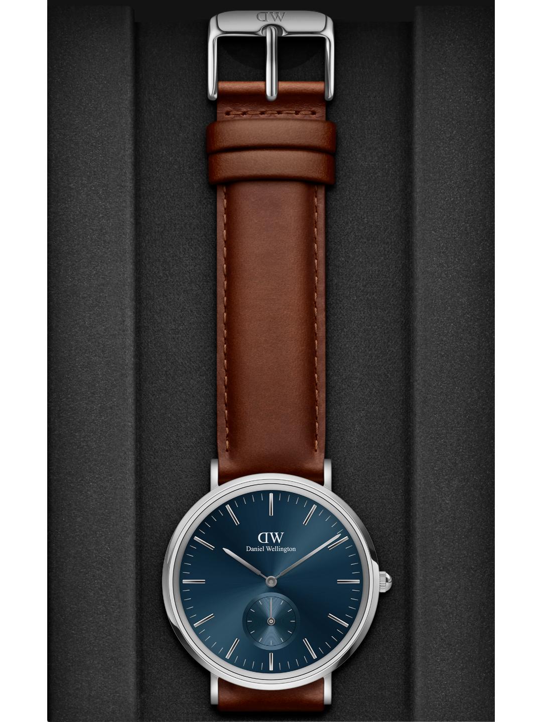 Watch with brown leather strap and blue dial on a gray background