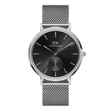 Daniel Wellington watch with black dial and silver mesh strap on a white background