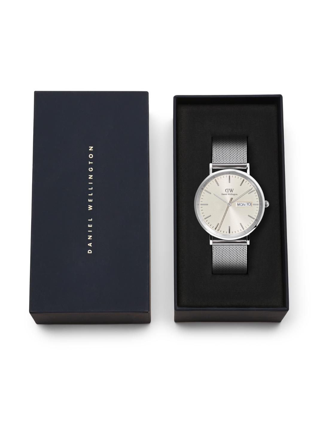 Silver watch in a black box with 'Daniel Wellington' branding on a white background