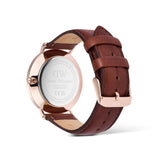 Watch with brown leather strap and rose gold case on a white background