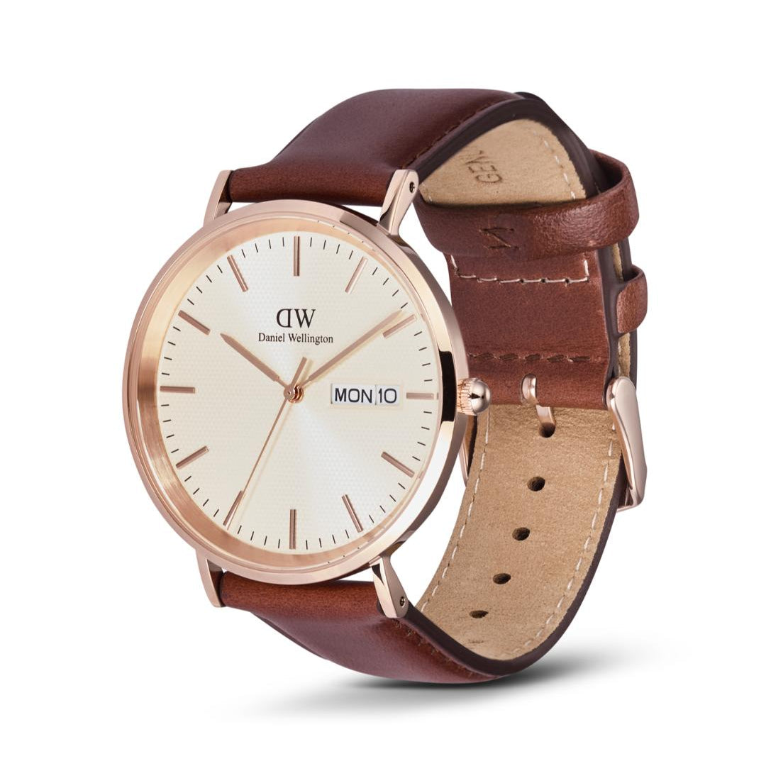 Watch with brown leather strap and rose gold case on white background
