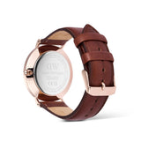 Watch with brown leather strap and rose gold case on a white background