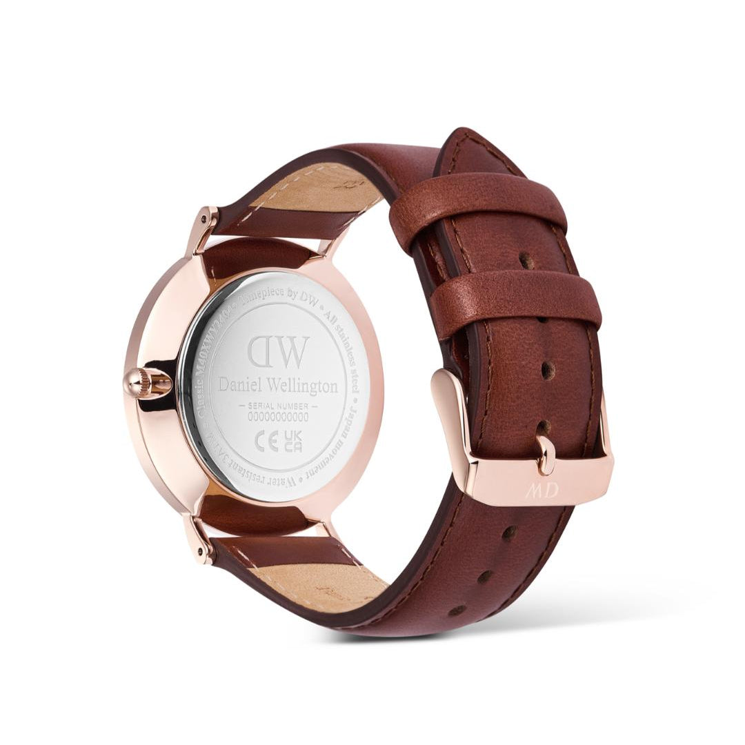 Watch with brown leather strap and rose gold case on a white background