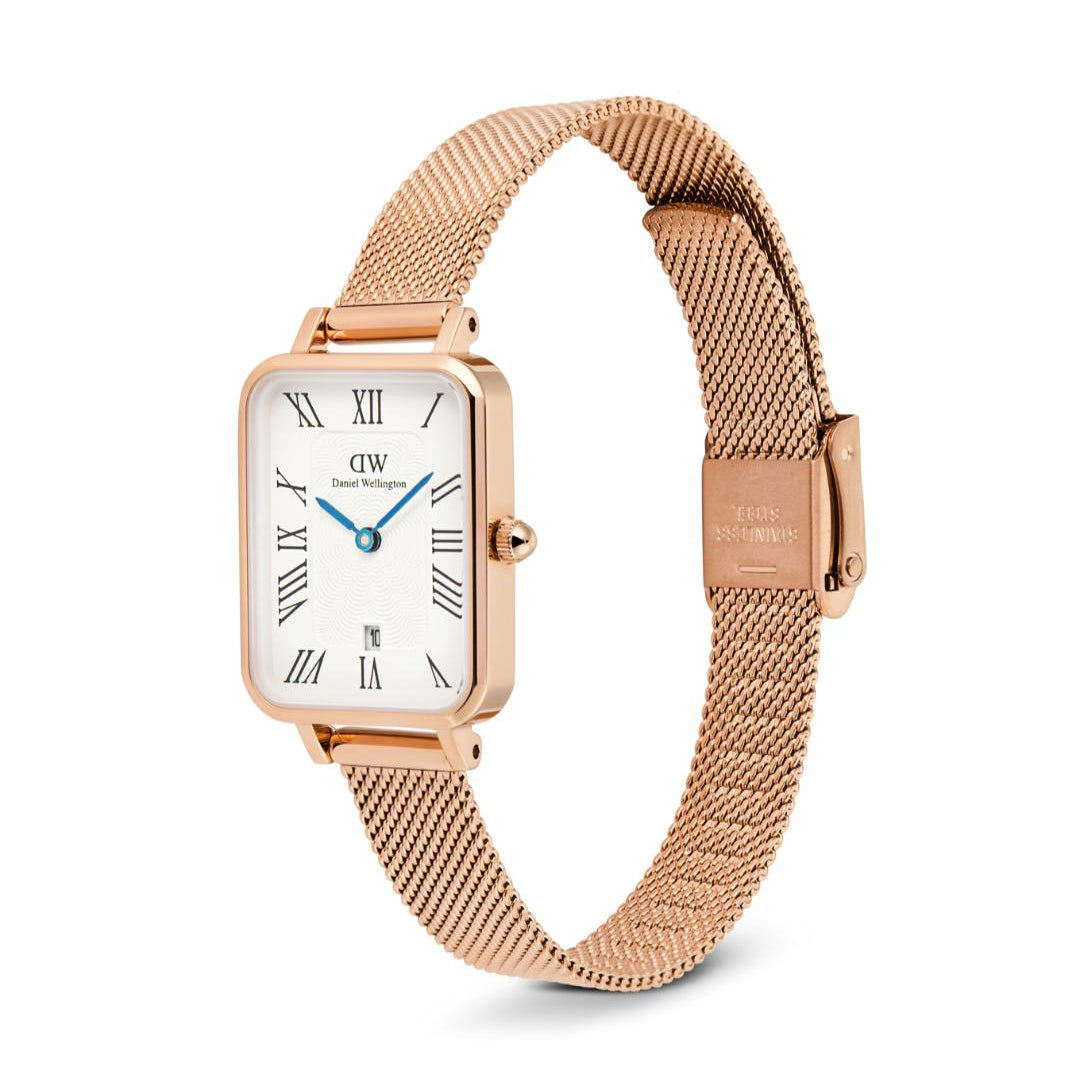 Rose gold watch with a white face on a white background
