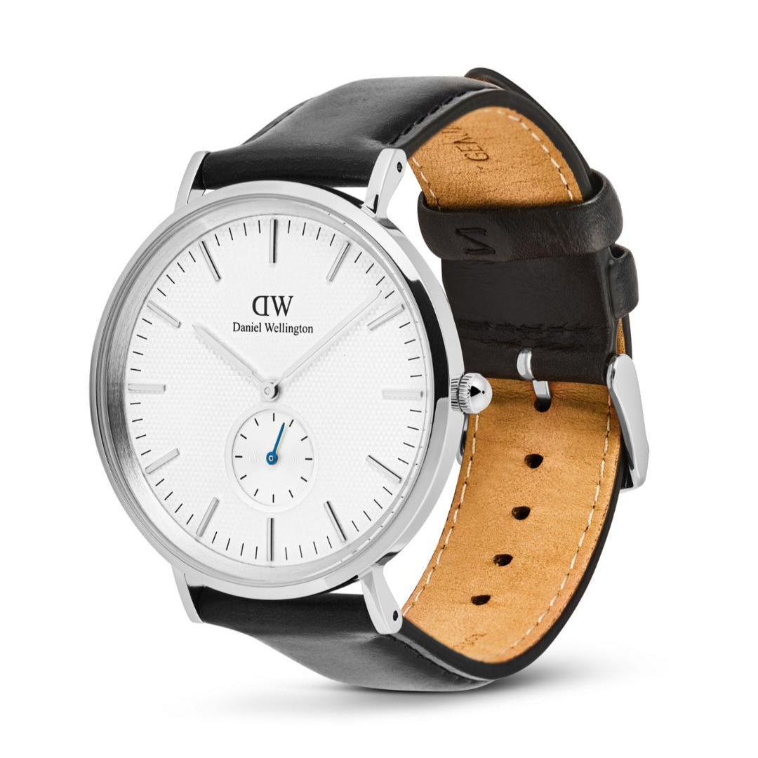 Daniel Wellington watch with black and brown leather straps on a white background