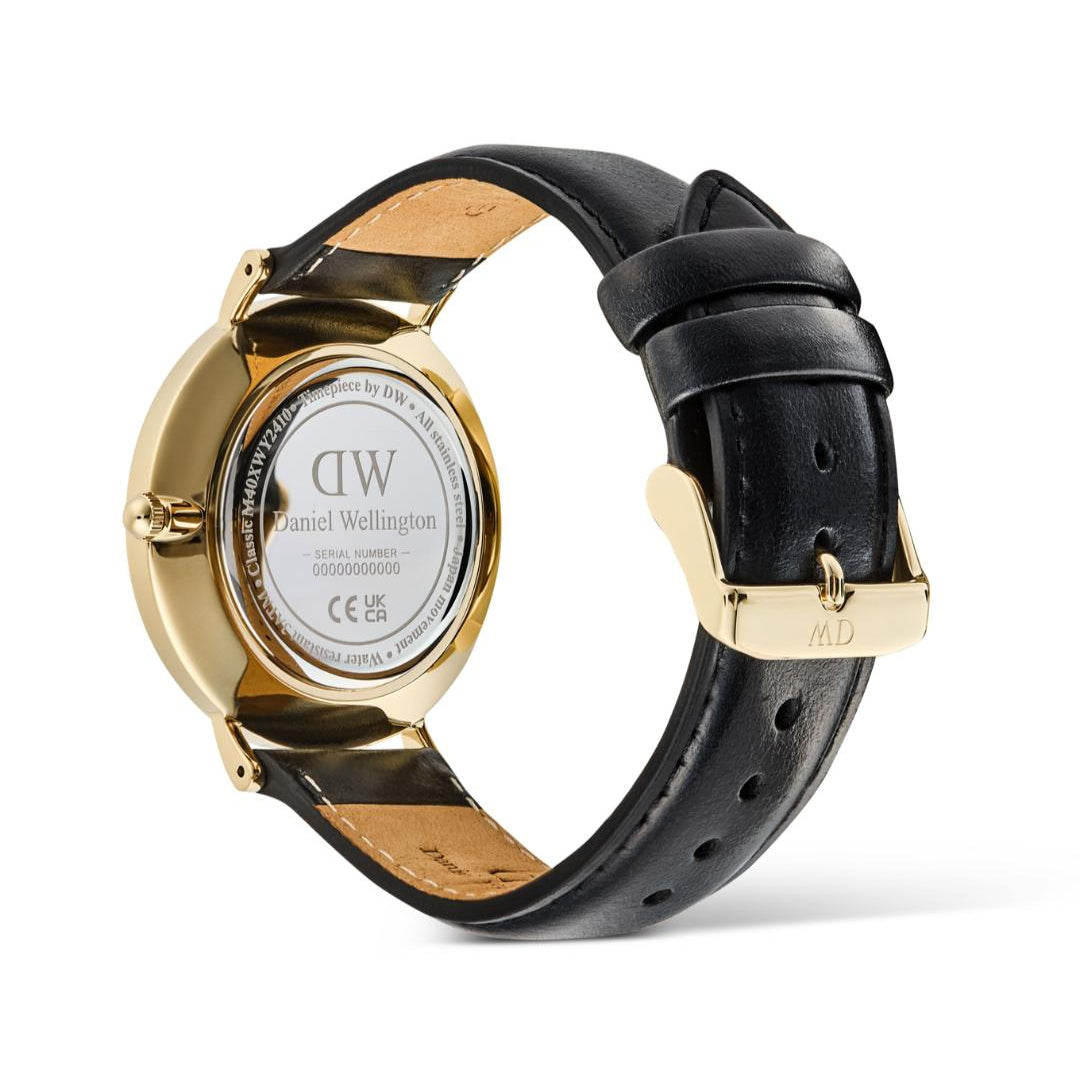 Watch with black leather strap and gold case on a white background