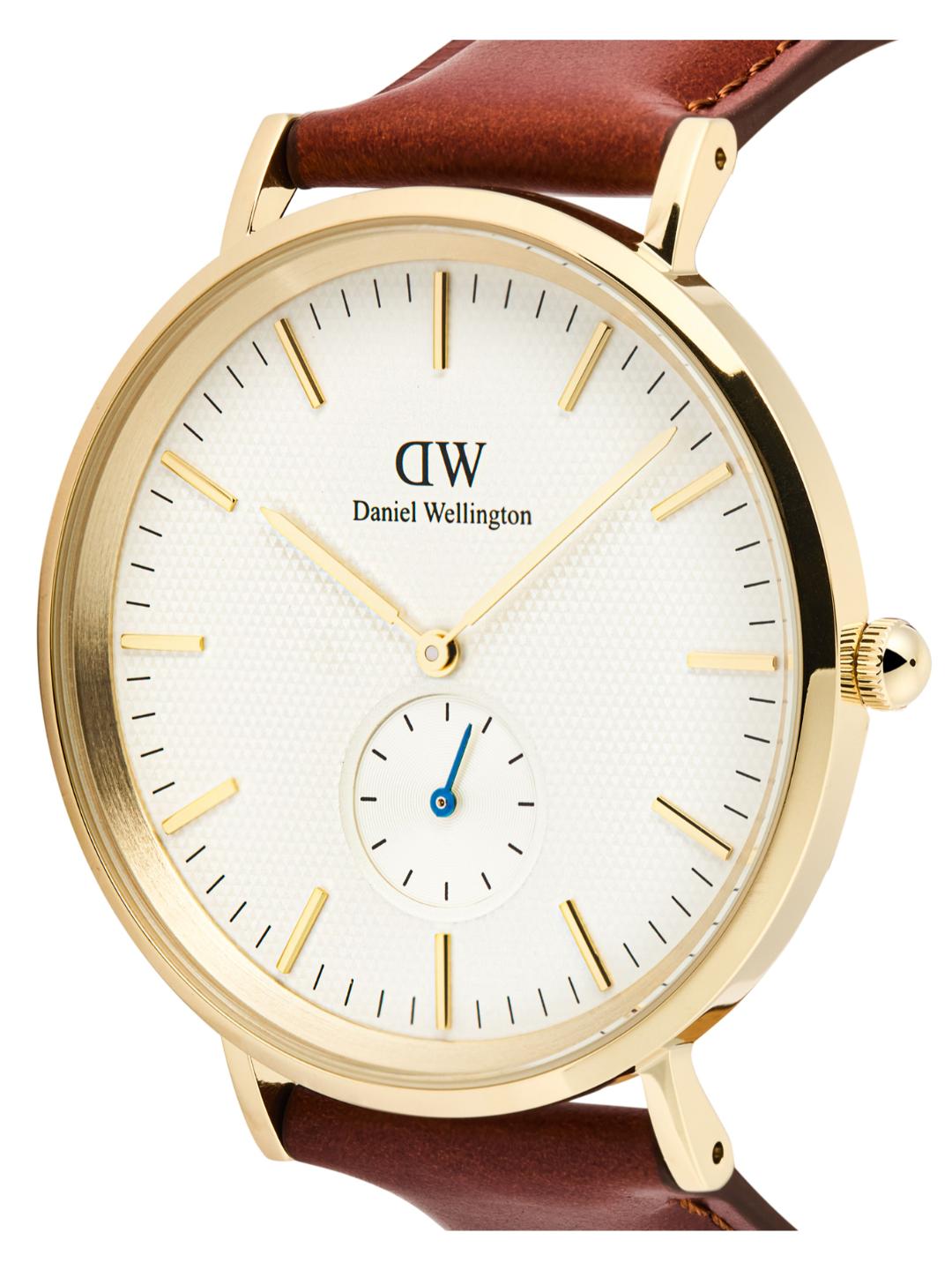 Daniel Wellington watch with gold case and brown leather strap on a white background