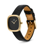 Watch with black face, gold bezel, and black leather strap on a white background