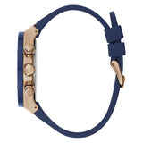 A close-up side view of a watch with a navy blue silicone strap and a rose gold-toned case featuring three pushers, set against a plain white background.