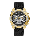A GUESS men's chronograph watch featuring a gold-tone case accented with clear crystals, a black dial with silver sub-dials, and a textured black silicone strap, shown against a plain white background.