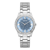 A Guess branded analog women's watch with a blue dial and a silver stainless steel band, featuring a diamond-accented bezel.