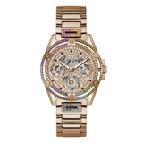 A rose gold Guess wristwatch with a multi-functional dial, crystal-encrusted bezel, and a matching crystal-embellished link bracelet on a white background.
