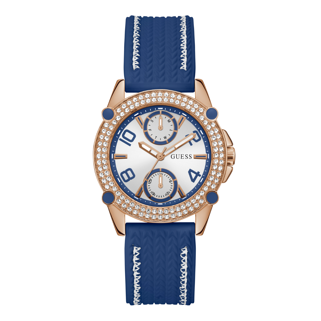 A women's GUESS watch featuring a rose gold case, a bezel encrusted with clear crystals, a white dial with blue accents and sub-dials, and a textured blue silicone strap with white chevron patterns.