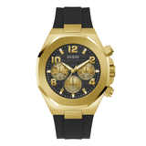 A GUESS men's chronograph watch featuring a brushed gold-tone case, a black dial with gold subdials and markers, and a black silicone strap with gold accents, shown against a plain white background.