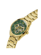 Gold watch with a green face on a white background