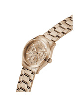 A GUESS women's analog watch with a rose gold-tone metal case and link bracelet, featuring a textured dial with multiple sub-dials.