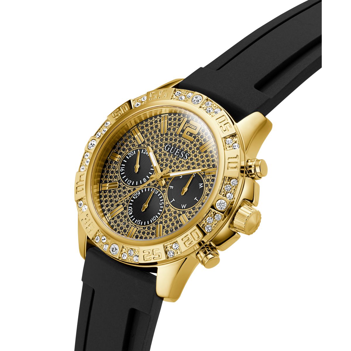 A gold-tone Guess chronograph watch with a black textured dial, black sub-dials, a bezel set with clear crystals, and a black rubber strap, shown on a white background.